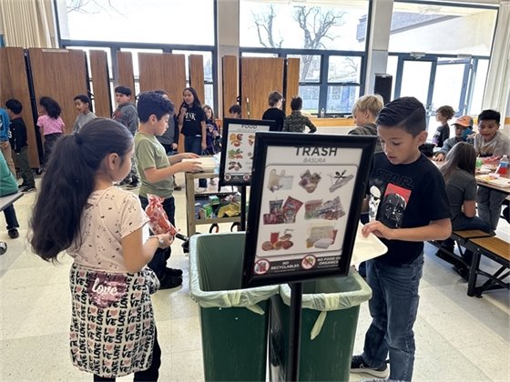 children recycling and sorting food waste at lunch time