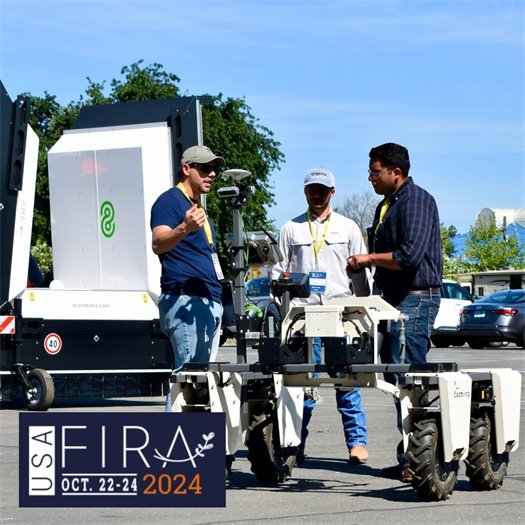 Photo of people talking next to ag robot