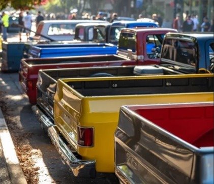 photo of a past C-10 event in Downtown Woodland with multiple custom trucks in foreground