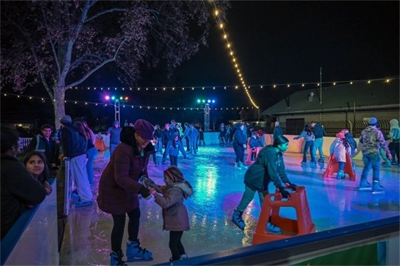 Families skating at the downtown ice rink in 2024