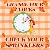 Change your Clocks - Check Your Sprinklers - Person standing in front of clock with an umbrella