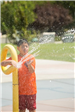 Boy Shooting Water Out of Splash Pool Feature