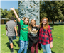 Three girls by rock climbing wall