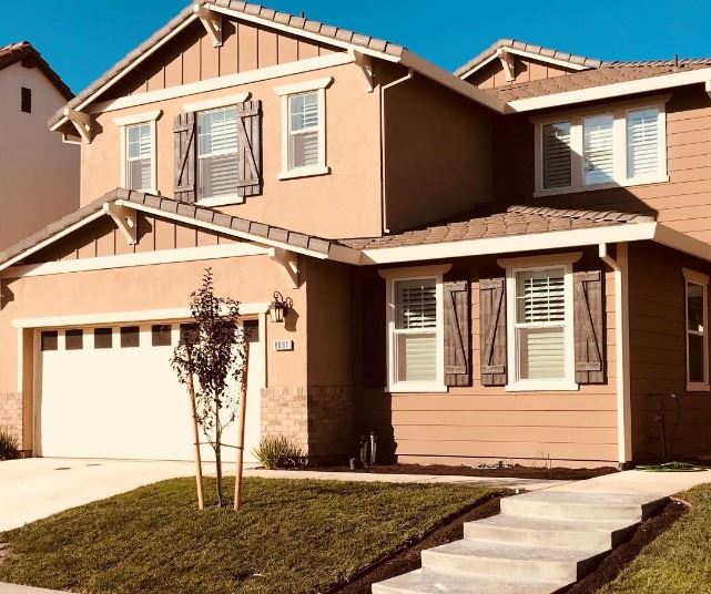 Tan stucco exterior two story single family residence